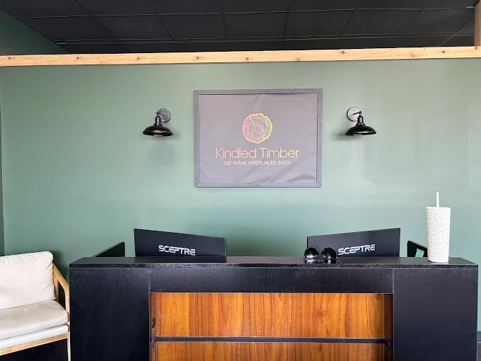 The front desk at the Kindled Timber showroom, the logo on the wall behind it